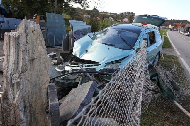 Auto bei Verkehrsunfall in Wels-Oberthan in Ausstellungsgelände eines Steinmetzbetriebes gekracht