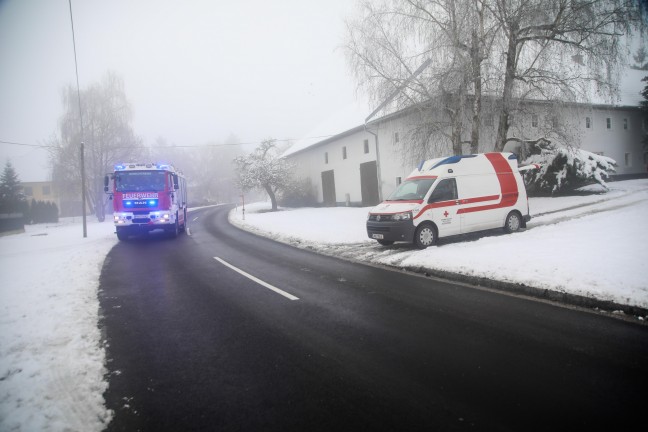 Rettungsfahrzeug bei Hofzufahrt in Marchtrenk im Schnee und Matsch festgefahren