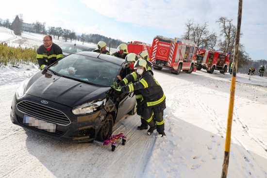 Kollision zweier Autos in schneeglatter Kurve in Laakirchen