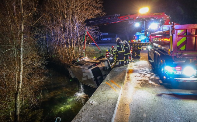Kleintransporter bei schwerem Verkehrsunfall in Steinerkirchen an der Traun in Mühlbach gestürzt